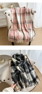 Detailed texture of thick plaid scarf featuring soft cashmere-like fabric and long tassels