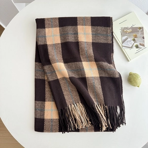 Classic plaid scarf in coffee and camel with long tassels on a white surface