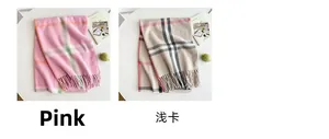 Detail shot of classic pink and beige checkered cashmere-feel scarves with fringe