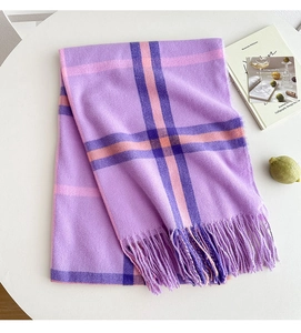 Detail of purple plaid cashmere-feel scarf with long tassels and soft fabric texture
