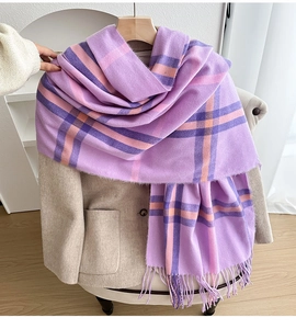 Detail of British style check scarf with soft purple fringe on a beige coat display