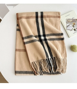 Detailed view of the classic plaid pattern and fringe edge of the cashmere scarf