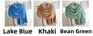 Detail view of solid-colored scarves with tassels in Lake Blue, Khaki, and Bean Green