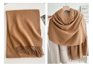 Detail of solid camel tassel scarf showing thick cashmere-like texture and soft drape