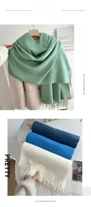 Close-up of thick imitation cashmere scarves with soft fringe details in multiple colors