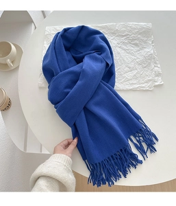 Close-up of royal blue tassel scarf with soft cashmere-like texture and fine knitting