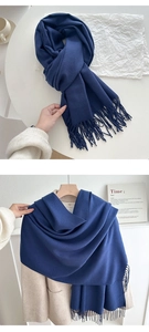 Detailed view of navy blue tassel scarf texture and styling with a beige autumn coat