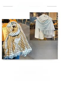 Detail of thick black and white plaid scarf featuring classic fringe edges for winter