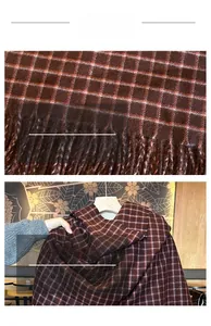 Close-up of soft brown plaid scarf featuring a classic checkered pattern and fringe tassels