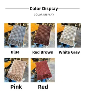 Detailed color display of plaid scarves with fringe edges in red, blue, and pink tones