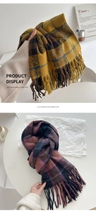 Detail of plaid imitation cashmere scarf with long tassels and soft fabric texture