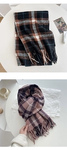 Close-up of thick winter plaid scarf with fringe tassels and soft brushed texture