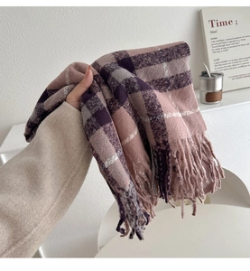 Detailed close-up of pink and grey checkered winter scarf with soft fringed edges