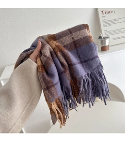 Close-up of purple and brown plaid scarf with soft texture and long tassels detail