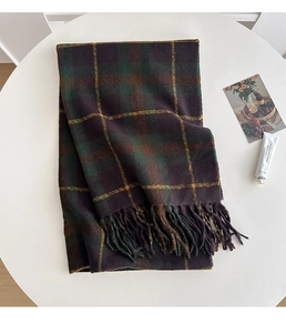 Detail of vintage plaid scarf with long tassels and thick warm winter fabric texture