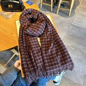 Classic red plaid scarf with tassels on vintage dark brown wool blend fabric