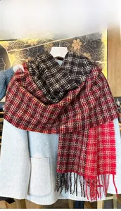Detail shot of heavy-knit checkered scarf with long tassels and soft brushed texture