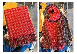 Macro detail of thick checkered scarf showing soft texture and long fringe trim details