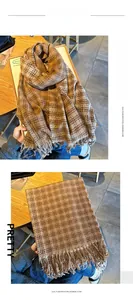 Detail of soft brown plaid imitation cashmere scarf with decorative tassels