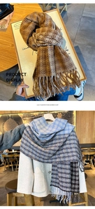 Detail shot of brown and blue plaid scarf showing soft cashmere texture and tassel edges