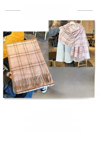 Detail of pink and brown checkered scarf featuring thick texture and tassel edges