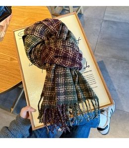 Detail of checkered tassel scarf with thick purple and green knit texture on wooden frame