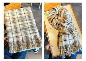 Detail view of plaid winter scarves with long tassels in green and brown patterns