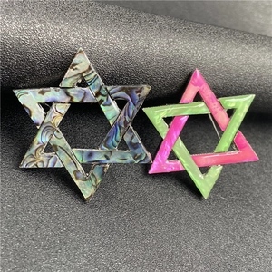 Detailed view of hexagram brooch set with natural abalone shell and colorful shell inlay