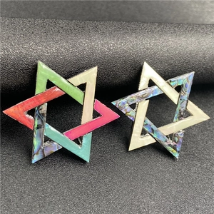 Close-up of hexagonal star brooches with colorful abalone shell and mother of pearl