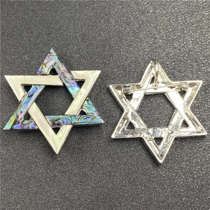 Macro view of abalone shell hexagram star brooch with silver metal pins and back detail