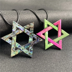 Macro detail of Hexagram pendant with natural abalone shell inlay on black cord
