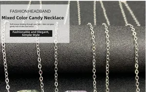 Detail of candy-colored faceted crystal pendants on silver chains displayed on a stand
