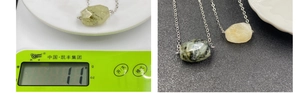 Detailed view of faceted natural crystal pendants on scale showing weight 11g