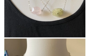 Detail of faceted rose quartz and yellow rutilated quartz pendants on silver chains