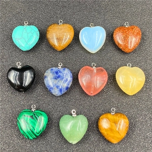 Detailed view of eleven heart-shaped natural crystal and semi-precious stone pendants