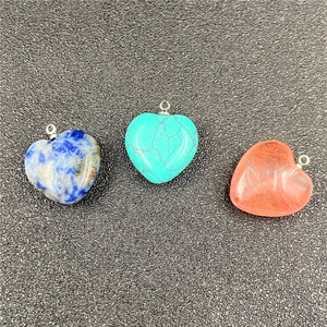 Close-up of heart-shaped natural stone and resin pendants with silver metal loops