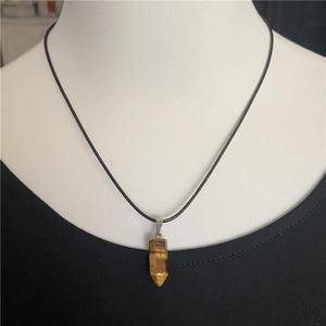 Tiger eye stone hexagonal pillar pendant necklace displayed on a black cord
