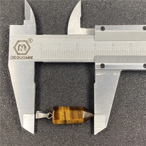 Tiger eye crystal hexagonal pendant measured with caliper showing 3.2cm length