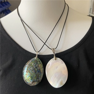 Oval abalone shell and white mother-of-pearl pendants on black leather cord necklaces