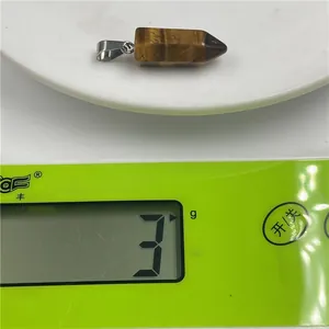 Tiger eye crystal hexagonal pendant weighing 3g on a precise digital jewelry scale