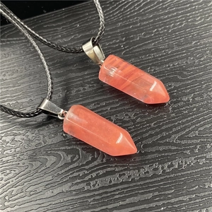 Detail view of hexagonal crystal pendants with natural strawberry quartz texture