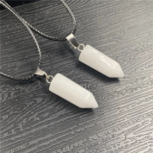 Detailed macro view of two white hexagonal crystal pendants with silver metal clasps