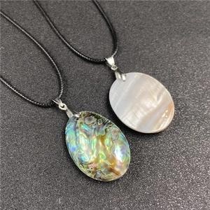 Detail of oval abalone and mother of pearl pendants with black woven cords