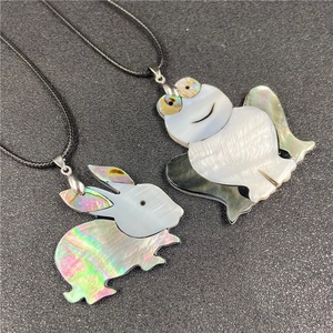 Handcrafted animal shell pendants with rabbit and frog designs on black woven cords