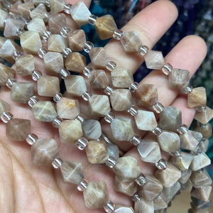 Macro detail of faceted sunstone beads showing natural mineral textures and geometric cuts