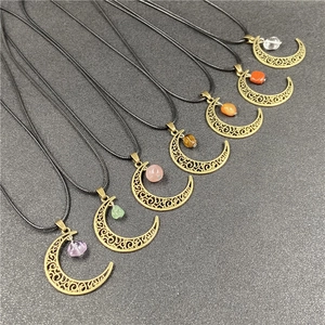 Close-up of seven bronze crescent moon pendants with various colorful gemstone beads
