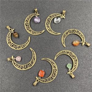 Set of seven bronze moon pendants with assorted raw natural gemstones in a boho style