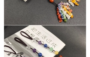 Macro shot of colorful natural crystal beads and hand-woven brown cords on a book