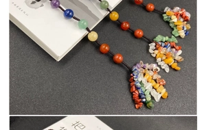 Close-up of a colorful natural crystal stone tassel pendant with vibrant round beads