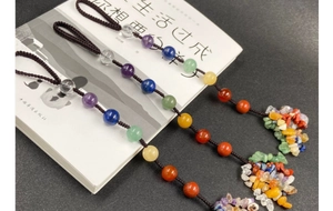 Detailed view of three handcrafted chakra gemstone hanging ornaments with tassels